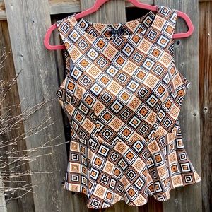 Cute shell with peplum detail and striking fabric